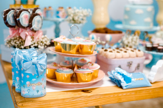 Colorful dessert table with tiered cupcake stands and coordinated party treats