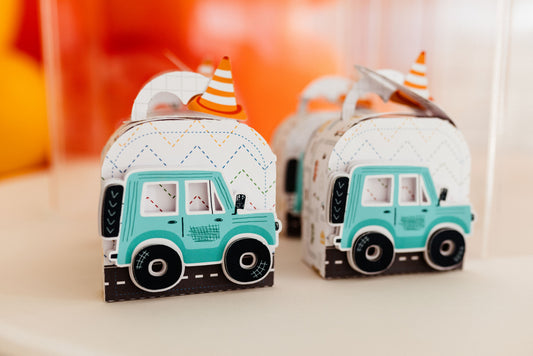 Colorful car-themed party favor boxes arranged on a table for a kids birthday party