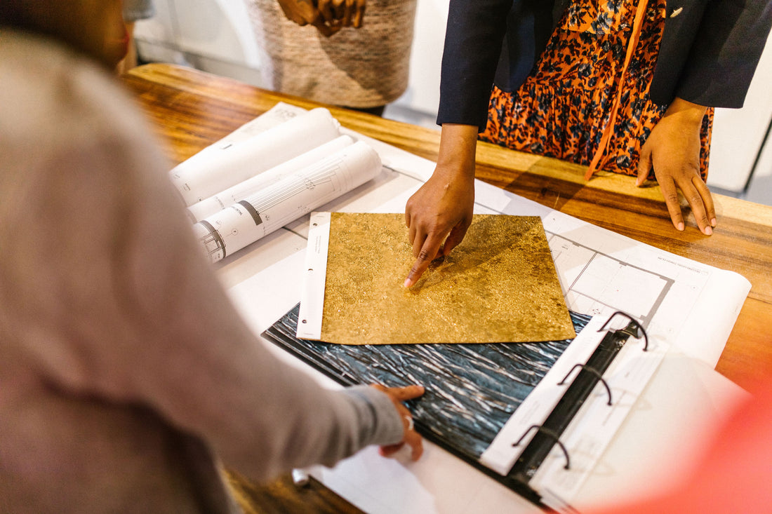 Event stylists reviewing fabric swatches and floor plans on a planning table