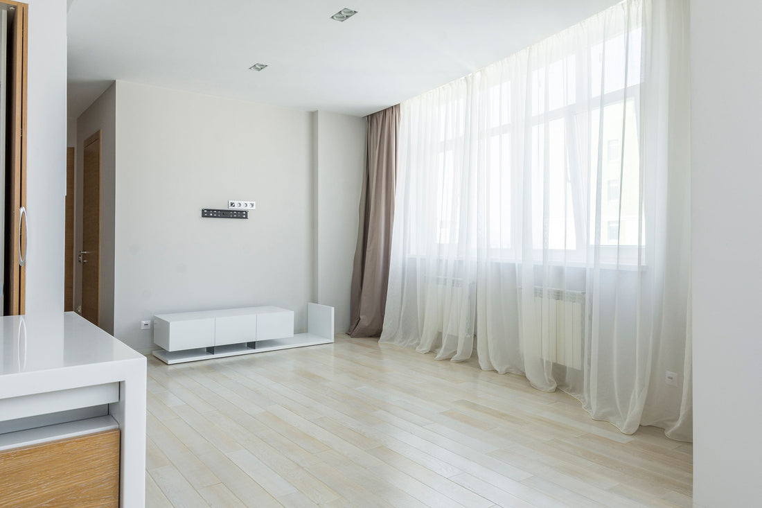 Bright living room with a sheer curtain hanging against a plain wall, an easy stand-free backdrop setup
