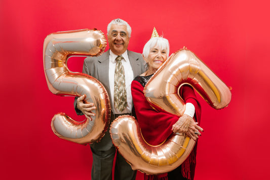 Guests celebrating a birthday party against a vibrant red backdrop